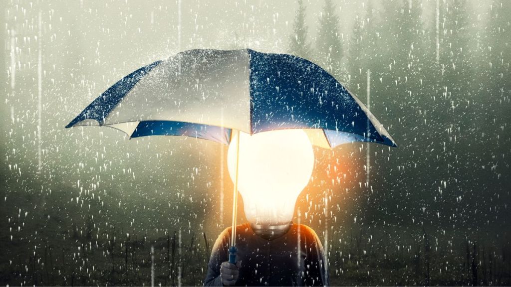 An abstract image of a man holding an umbrella in the rain and having a glowing light bulb as a head