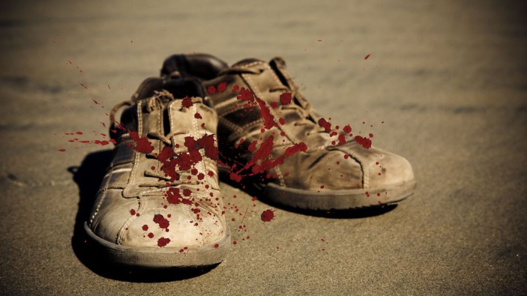 A pair of dirty, blood spattered canvas sneakers