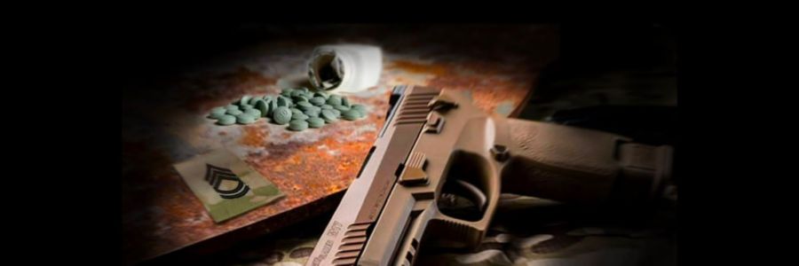 A firearm and a bottle of spilled green pills against a black background